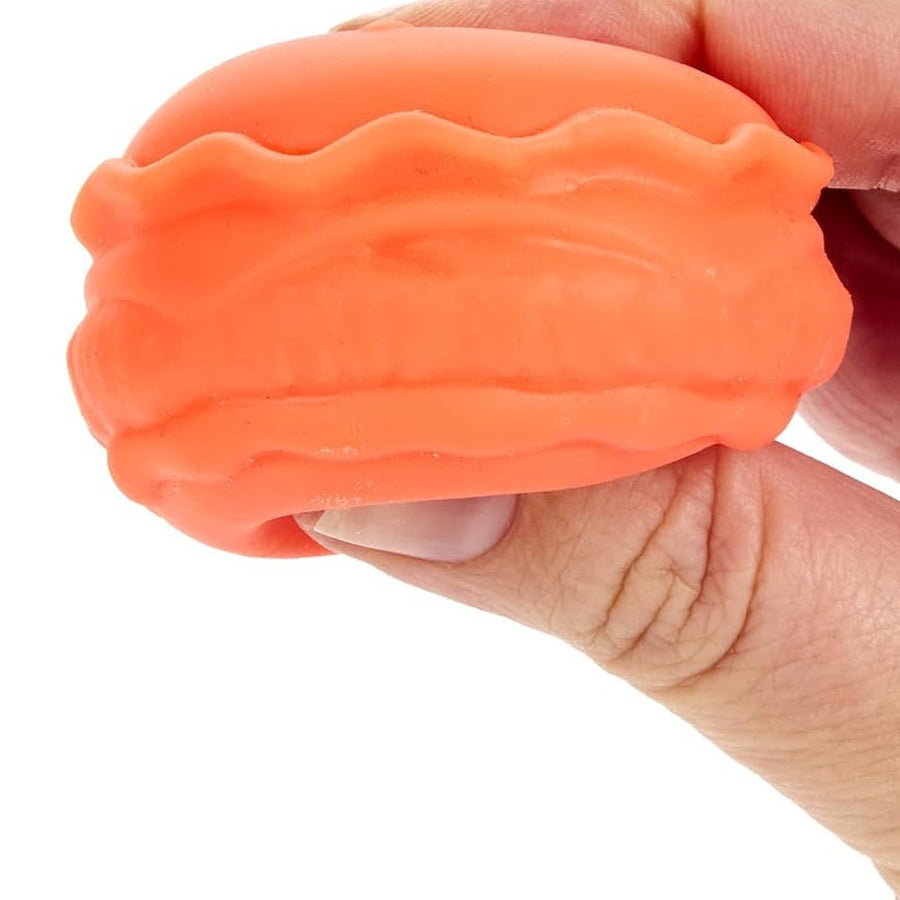 Hand squishing an orange mini NeeDoh squishy